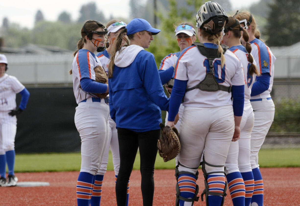 Ridgefield coach Kelsey Anchors talks to the team after calling for time in the first inning of a Class 2A District 4 tournament softball game against Rochester on Friday, May 17, 2024, in Chehails.