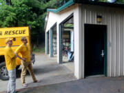 Silver Star Search and Rescue medical officer Jeff Berner, right, and board member Tom Nichols look at the front of East County Fire and Rescue&rsquo;s Station 92 on May 13.