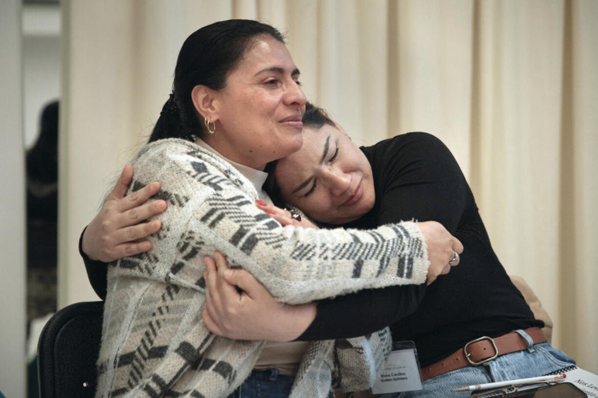 Claudia Saenz, left, and Diana Carolina Guillen hug and cry during a sexual harassment prevention class for nannies and housekeepers on Saturday, April 27, 2024, in the Brooklyn borough of New York. Nannies, housekeepers, and home care workers are excluded from many federal workplace protections in the United States, and the private, home-based nature of the work means abuse tends to happen behind closed doors.
