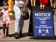 A young shopper, wearing a mask to protect herself from the coronavirus, shops with her mother on Santee Alley in the Garment District in downtown Los Angeles in June 2020. The pandemic accelerated mistrust in government, institutions &Ccedil;&fnof;&Oacute; and science .