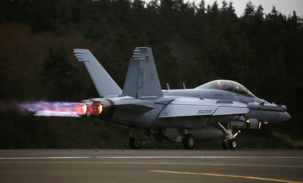 An EA-18G Growler engine&rsquo;s thrust with afterburner propels its takeoff with a loud roar from Naval Air Station Whidbey Island during an exercise, Thursday, March 10, 2016.