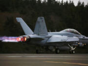 An EA-18G Growler engine&rsquo;s thrust with afterburner propels its takeoff with a loud roar from Naval Air Station Whidbey Island during an exercise, Thursday, March 10, 2016.