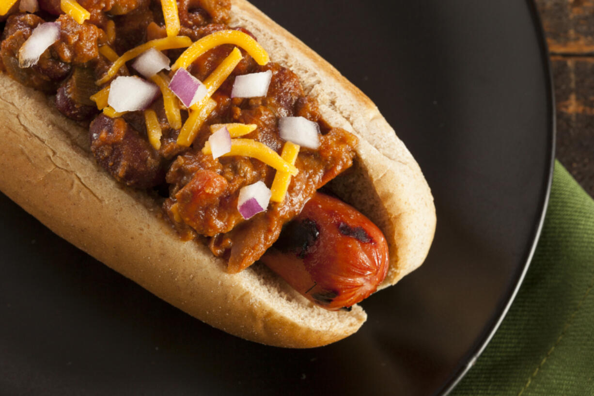 Top a grilled hot dog with a quick Detriot-style chili, cheddar cheese and onions.