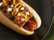 Top a grilled hot dog with a quick Detriot-style chili, cheddar cheese and onions.