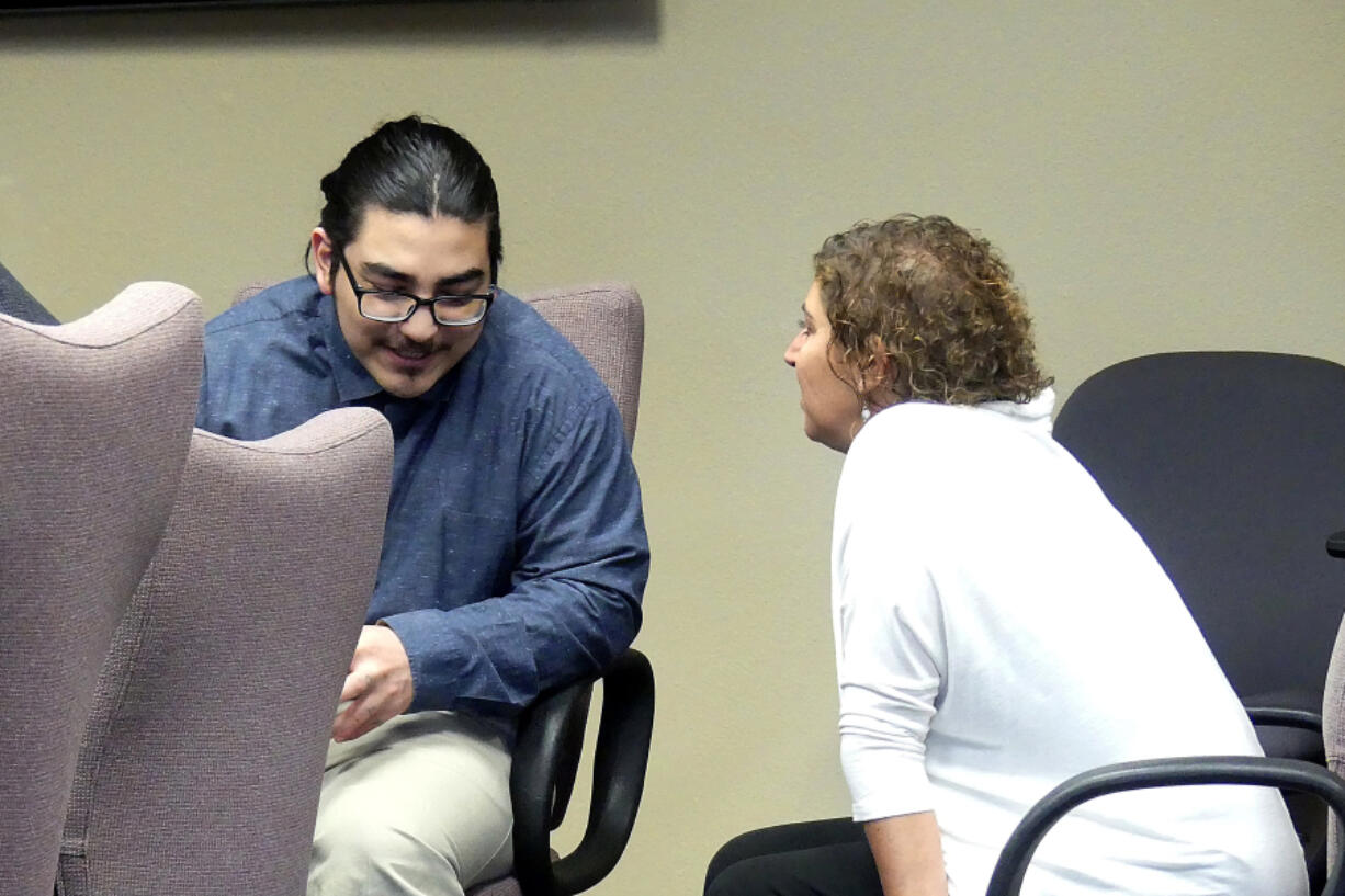 Julio Segura, 23, of Yakima speaks with his defense team Thursday before the start of the 12th day of his murder trial in Clark County Superior Court. Segura is accused in the death of off-duty Vancouver police Officer Donald Sahota.