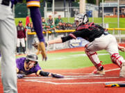 Columbia River's Charlie Palmersheim eludes a tag at home plate to score the go-ahead run in the seventh inning of a 3-2 win over Enumclaw in the Class 2A baseball state championship game on Saturday, May 25, 2024, in Bellingham.