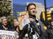 Catherine Berthet holds a photo of her daughter, Camille Geoffroy, after she and other relatives of those killed in two Boeing 737 Max crashes spoke at a federal court arraignment in Fort Worth, Texas, in January 2023.