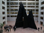 Members of the National Iranian American Council gather at the base of the &ldquo;Mountains and Clouds&rdquo; sculpture in the Hart Senate Office Building before delivering a petition to members of Congress on Capitol Hill Oct. 18, 2017, in Washington, D.C. With more than 43,000 signatures, the petition calls on Congress to pass legislation to rescind the latest version of the Trump Administration&rsquo;s travel ban.