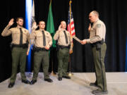 Clark County Sheriff John Horch, right, swears in new recruits, from left, Deputies Nathan Smith, Caleb Madarieta and Ryan Bylsma after they graduated May 21 from the regional law enforcement training academy in Vancouver during a ceremony at ilani. The new deputies were part of the first graduating class from the Vancouver academy, which opened in January at the former location of Image Elementary School.