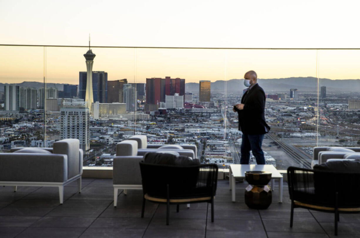 The sun sets on the city viewed from the outside deck within the Legacy Club at Circa on Dec. 22, 2020, in Las Vegas. (L.E.