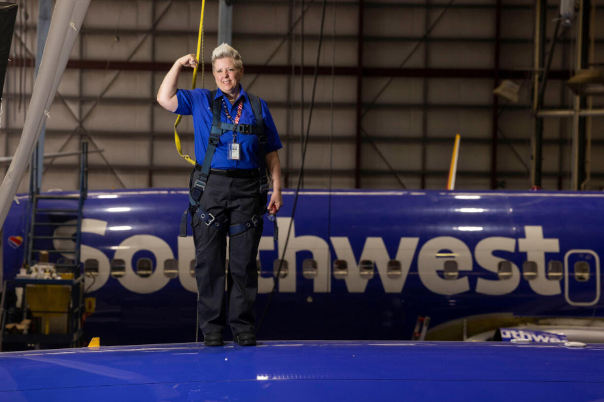 Jennifer Morgan, aircraft maintenance inspector, posed for a photo on top of a plane in Hangar 5 at the Southwest Airlines Headquarters in Dallas on April 14, 2023.