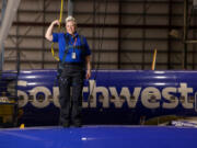 Jennifer Morgan, aircraft maintenance inspector, posed for a photo on top of a plane in Hangar 5 at the Southwest Airlines Headquarters in Dallas on April 14, 2023.