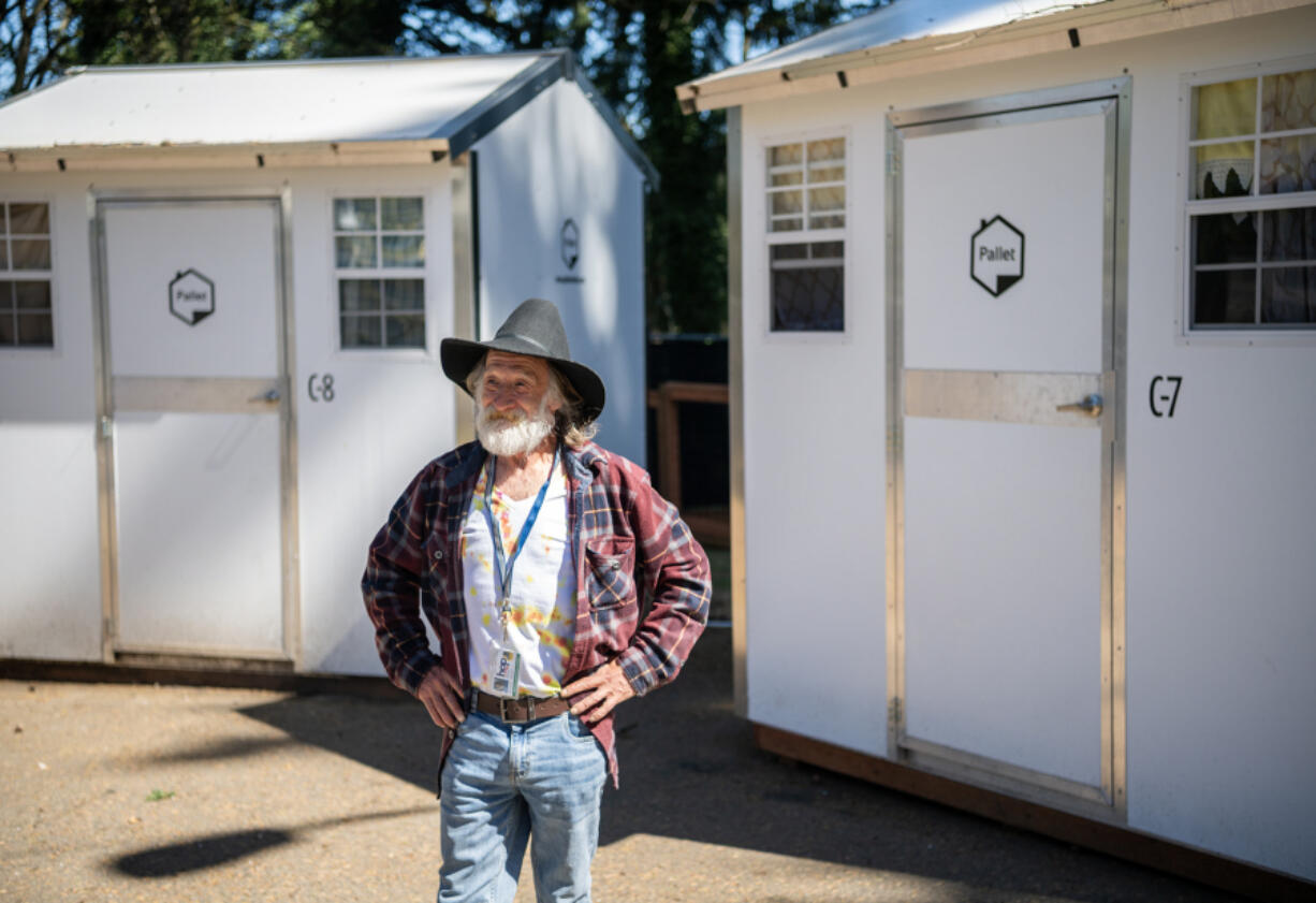 James McKinney stands outside his former pallet shelter at Vancouver&rsquo;s Kiggins Village Safe Stay community. McKinney recently moved into an apartment, which he views as his forever home.