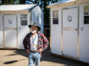 James McKinney stands outside his former pallet shelter at Vancouver&rsquo;s Kiggins Village Safe Stay community. McKinney recently moved into an apartment, which he views as his forever home.