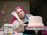 Jenn Hubbard decorates a cake May 21 at Hubbard&rsquo;s house in Vancouver. Hubbard began baking after her diabetic daughter beat kidney cancer and she wanted to make her a custom cake to celebrate.