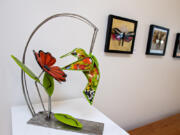 Bird with Flower by Sharon Agnor, left, and artwork by Cindy Geffel are among the pieces in the pollinators exhibit at Art at the CAVE gallery in Vancouver.