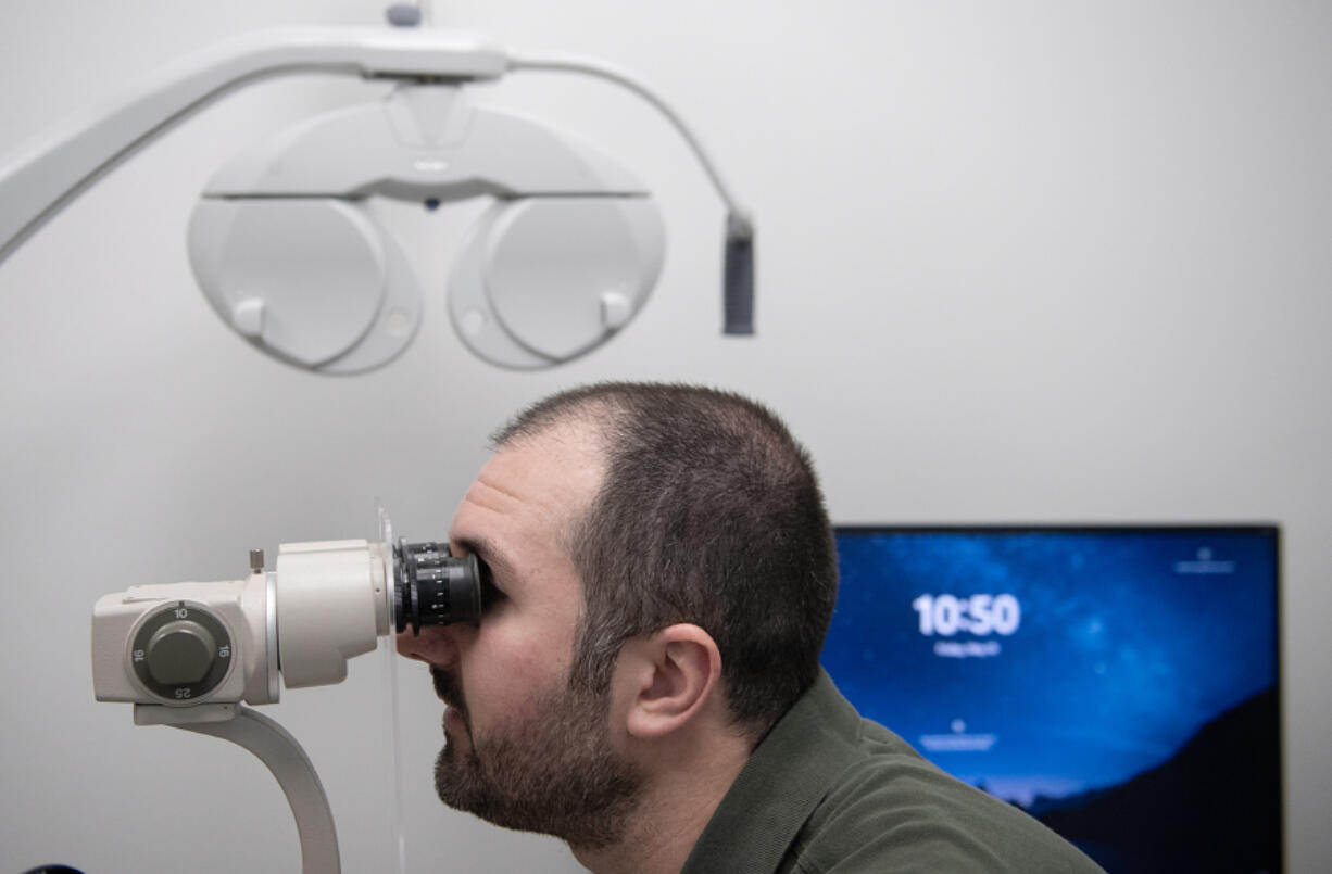 Dr. Nick Jankowski, lead optometrist at Mt. View EyeCare in Vancouver, uses the Ovitz medical system to analyze an eye during a demonstration Friday morning.