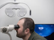 Dr. Nick Jankowski, lead optometrist at Mt. View EyeCare in Vancouver, uses the Ovitz medical system to analyze an eye during a demonstration Friday morning.