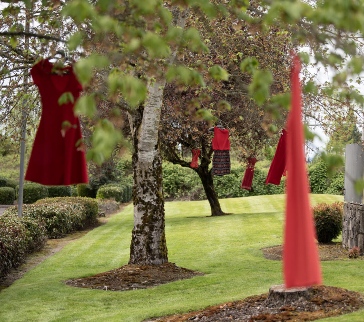 Red dresses representing murdered and missing Indigenous women hang from trees outside the Cowlitz Indian Tribe Health &amp; Human Services office in Hazel Dell on May 3. May is Missing and Murdered Indigenous People Awareness Month.