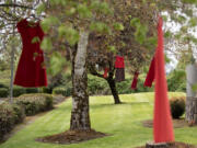 Red dresses representing murdered and missing Indigenous women hang from trees outside the Cowlitz Indian Tribe Health &amp; Human Services office in Hazel Dell on May 3. May is Missing and Murdered Indigenous People Awareness Month.