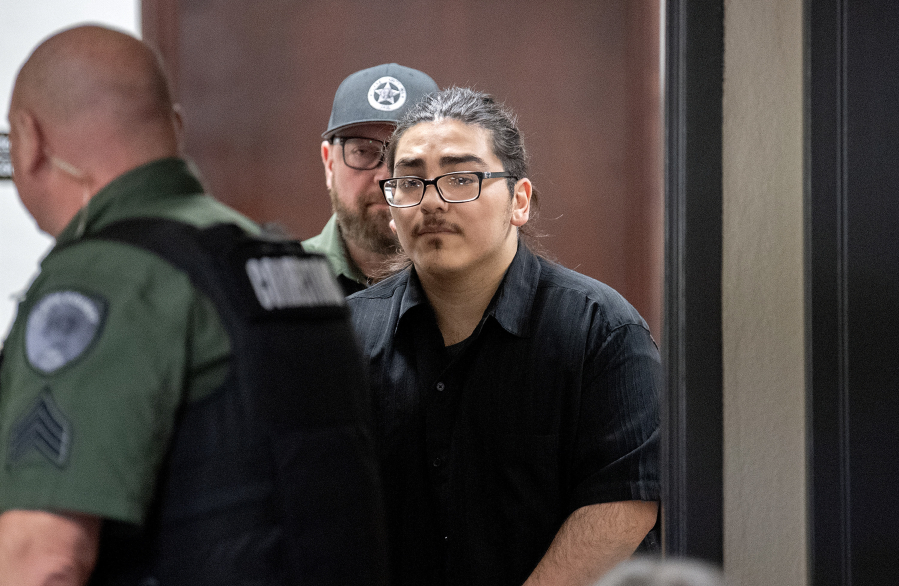 Julio Segura, 22, makes his way into the courtroom last week for his murder trial in the January 2022 death of off-duty Vancouver police Officer Donald Sahota at the Clark County Courthouse. The jury saw photos Monday of Sahota&rsquo;s injuries while first responders attempted to provide him medical aid.