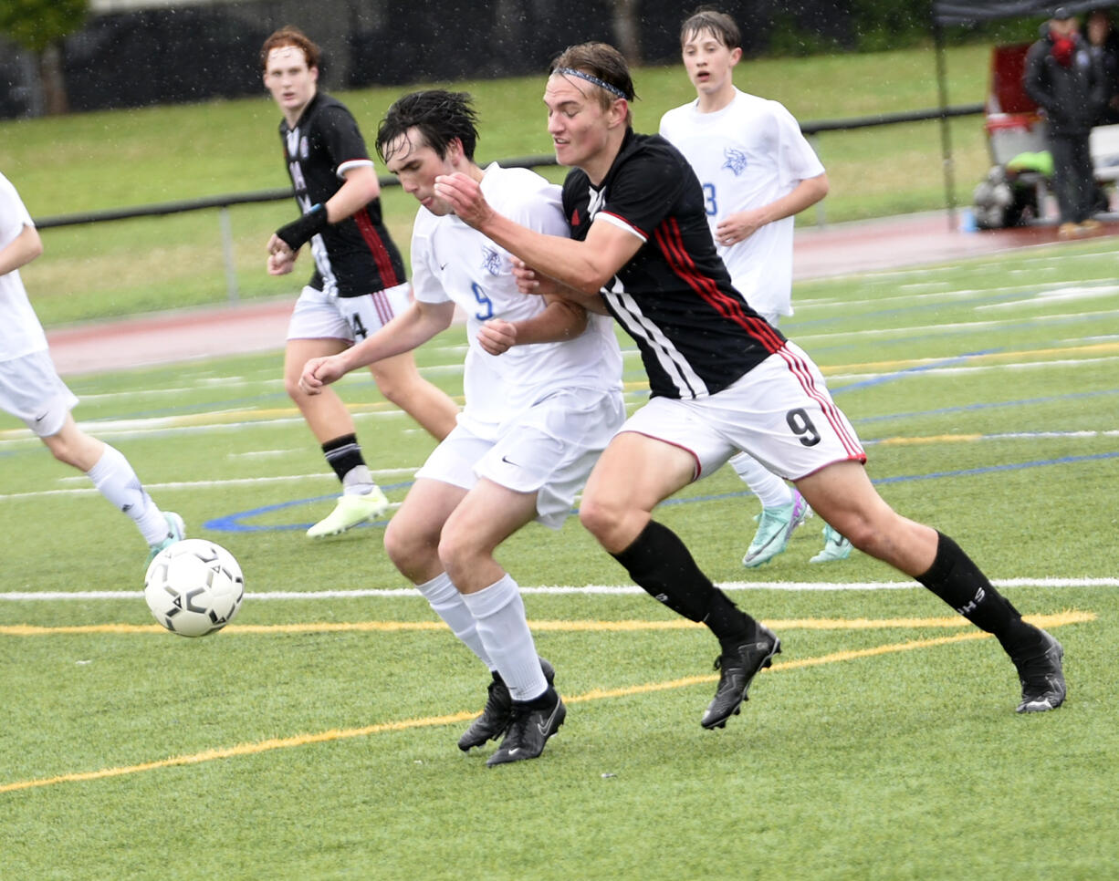 Eliot Herndon (right) of Union battles Ethan Bell of Curtis for the ball in a 4A bi-district boys soccer playoff at Union High School on Saturday, May 4, 2024.