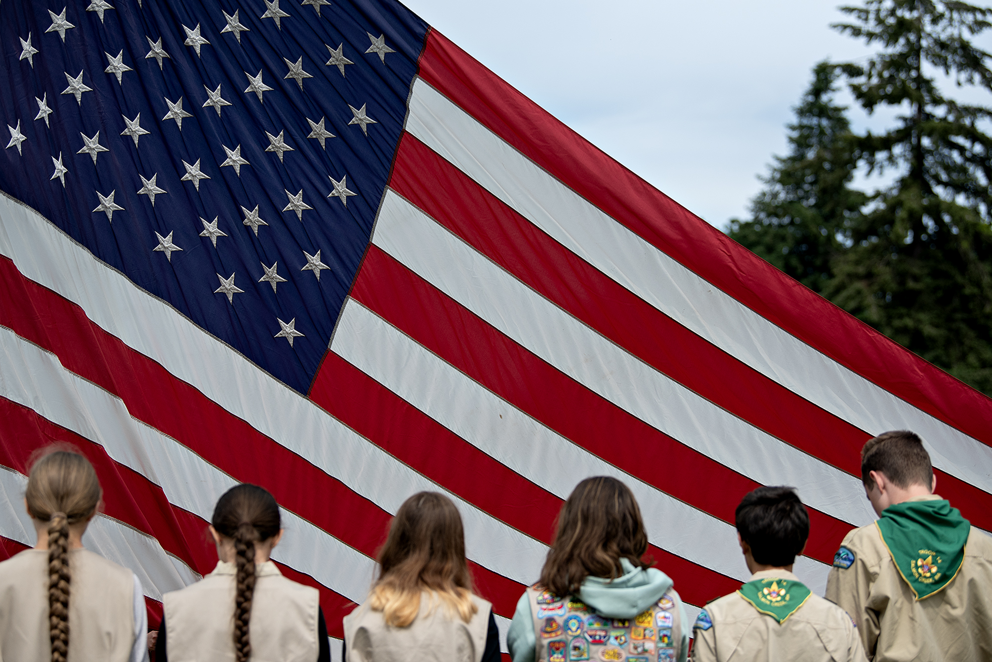 Members of the boy scouts and the girl scouts gather together to help with the raising of the American flag during the beginning of the annual Memorial Day service at Fort Vancouver National Historic Site on Monday morning, May 27, 2024.