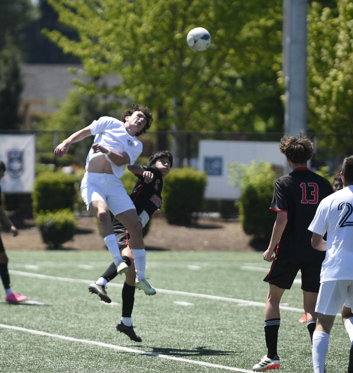 King's Way Christian's Luke Gomes, left, heads the ball over Columbia-White Salmon's Ulices Huerta during the Class 1A boys soccer District 4 championship match on Saturday, May 11, 2024 at Seton Catholic High School.