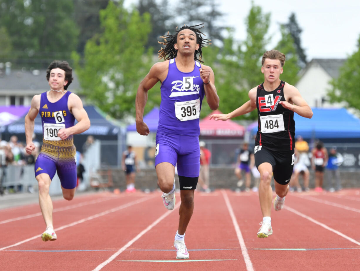 Columbia River&rsquo;s Revac Banfield, center, finishes a 2A boys 100 meter dash prelim race Friday, May 24, 2024, during the WIAA State Track and Field Championships at Mount Tahoma High School in Tacoma.