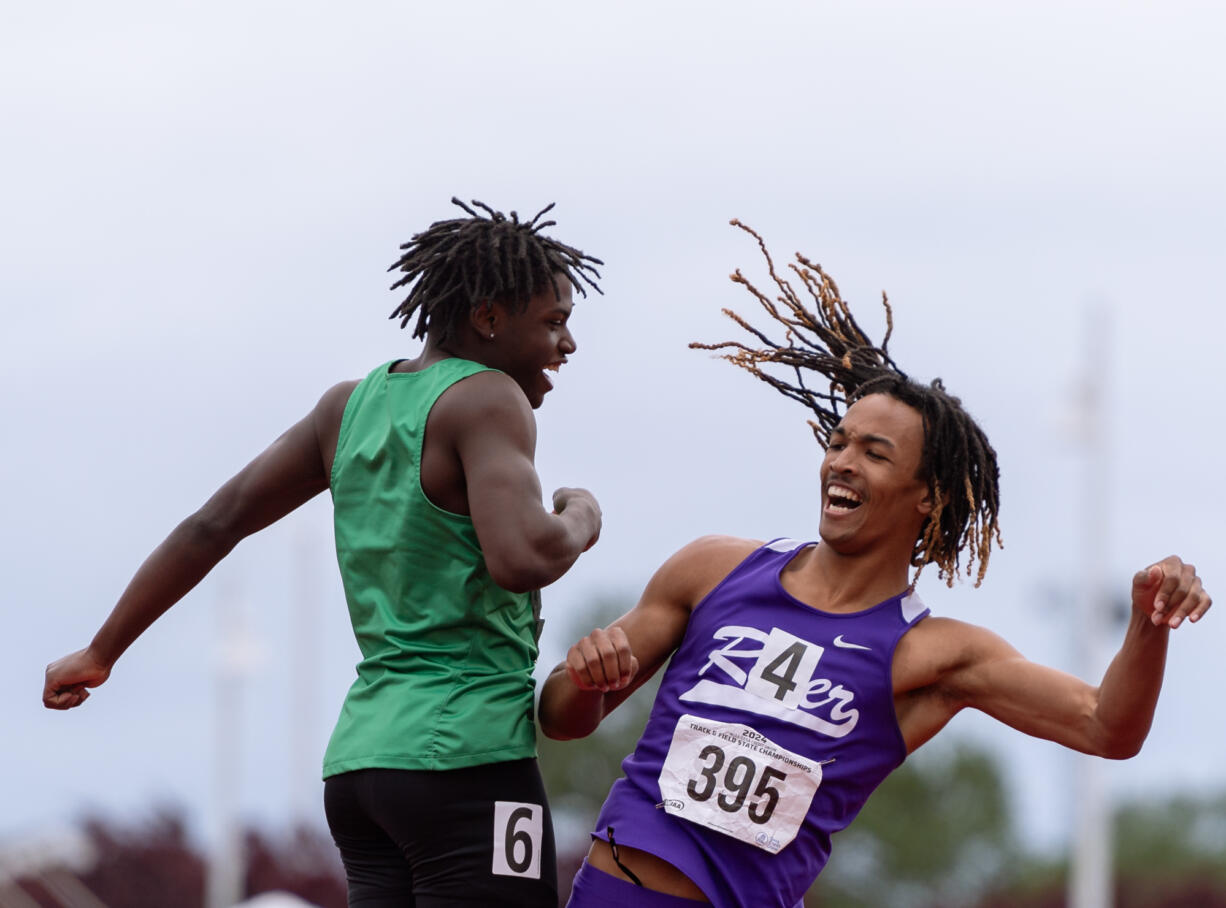 Columbia River’s Revac Banfield celebrates with second-place finisher Eli Peters, of Clover Park, after winning the 2A Boys 100 on Saturday, May 25, at the 2A/3A/4A State Track at Mount Tahoma High School in Tacoma.