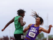 Columbia River’s Revac Banfield celebrates with second-place finisher Eli Peters, of Clover Park, after winning the 2A Boys 100 on Saturday, May 25, at the 2A/3A/4A State Track at Mount Tahoma High School in Tacoma.