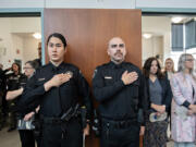 Officer Marcie Chamberlain, left, and Officer Ryan Aguilar of the Washougal Police Department honor the memory of fallen officers during the 2024 Clark County Law Enforcement Memorial Ceremony at the Public Service Center on Wednesday morning.