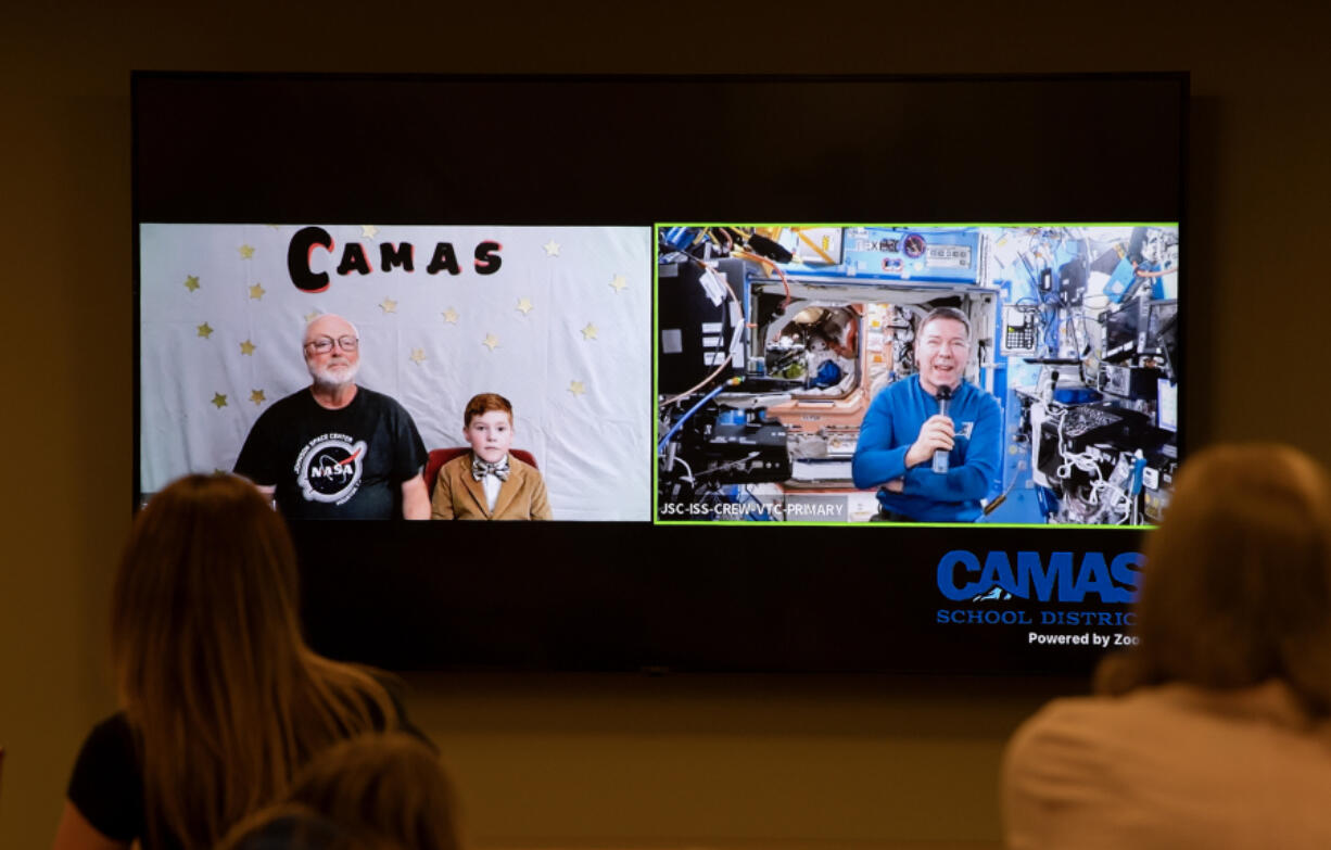 Former Camas High School science teacher Dale Croswell, left, emcees as second grader Miles Nichols of Lacamas Elementary School asks astronaut Michael Barratt a question about space via video link. Barratt, a graduate of Camas schools, is now aboard the International Space Station and will return to Earth in the fall.