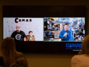 Former Camas High School science teacher Dale Croswell, left, emcees as second grader Miles Nichols of Lacamas Elementary School asks astronaut Michael Barratt a question about space via video link. Barratt, a graduate of Camas schools, is now aboard the International Space Station and will return to Earth in the fall.