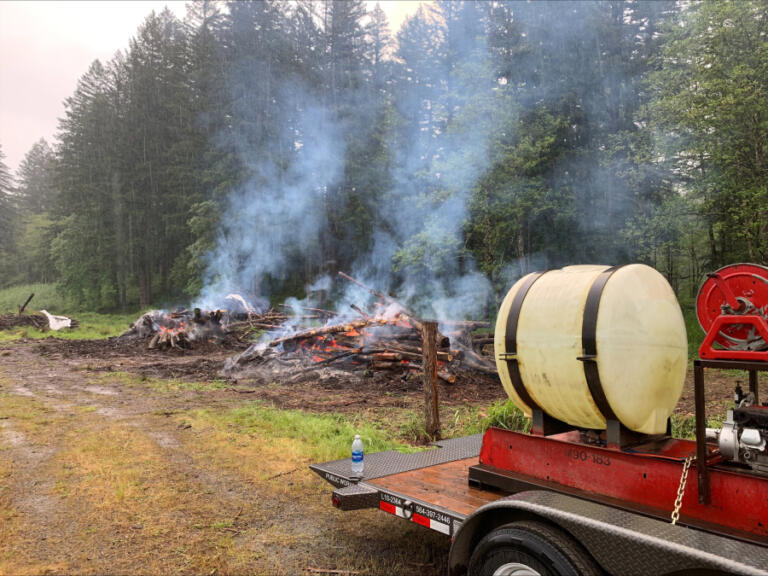 Crews from Clark County&rsquo;s sustainable forestry program are burning slash piles at Camp Bonneville, including this most recent burn May 21. The piles are burned to reduce available fire fuel and to clear areas for replanting.