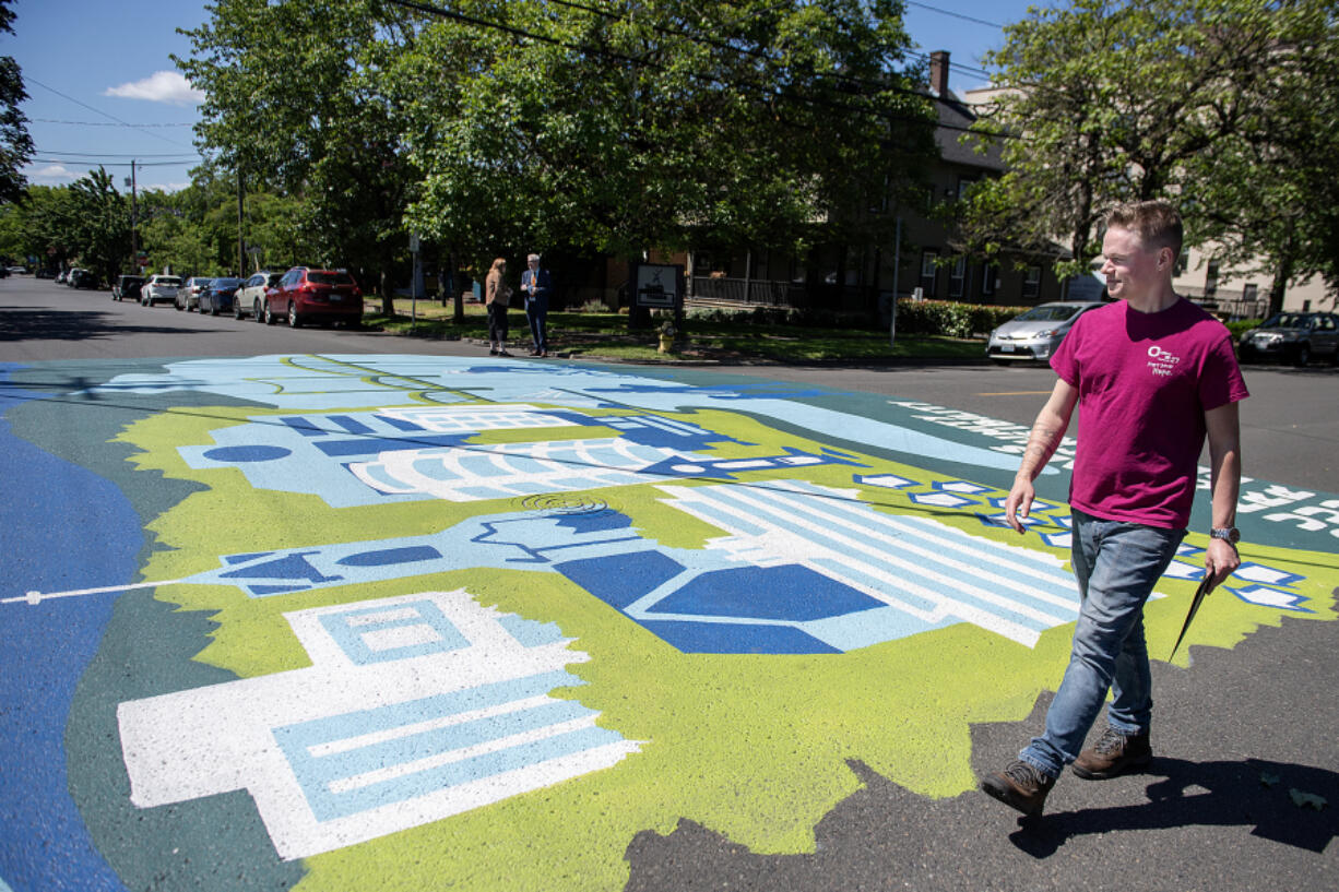 Artist Benji Todd walks past the new mural highlighting pedestrian safety he created in downtown Vancouver. The mural is part of an effort to reduce fatalities and serious injuries caused by crashes on our roads, with a focus on homeless people.