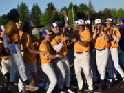 The members of the Columbia River baseball team celebrate with the district championship trophy after the Rapids' 9-2 win over W.F. West in the 4A district baseball championships at the Ridgefield Outdoor Recreation Center on Saturday, May 11, 2024.