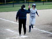 Skyview's Lainey Phillips, right, is congratulated by coach Kim Anthony after hitting a home run in the sixth inning of a quarterfinal game against South Kitsap in the Class 4A District 3/4 tournament on Friday, May 17, 2024 in Kent.