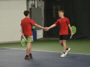 Tommy James (right) and Aiden Brasier of Camas congratulate each other after a point during the boys doubles championship match at the 4A state tennis tournament at The Pacific Clinic in Kennewick on Saturday, May 25, 2024.