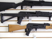 Semi-automatic rifles are displayed on a wall at a gun shop in Lynnwood.