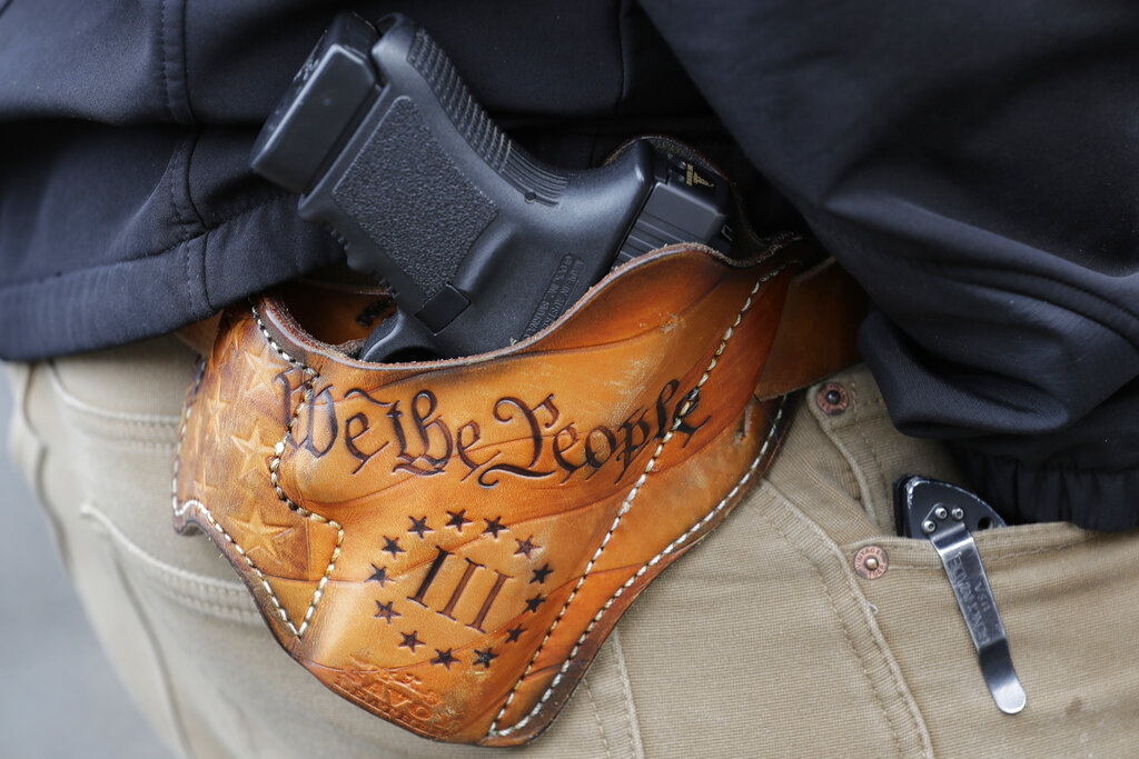 While it’s legal to openly carry a firearm in many public areas in Washington, as an open-carry state, it’s against the law to knowingly possess or carry one on the premises of a public or private elementary or secondary school, with a few exceptions, according to state statute.  (AP Photo/Ted S.