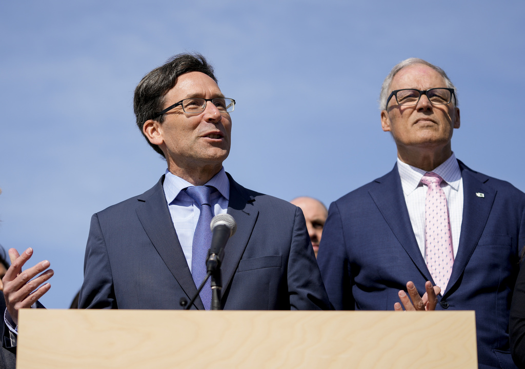 Washington Attorney General Bob Ferguson speaks as Washington Gov. Jay Inslee, right, looks on before the signing of several bills aimed at protecting reproductive health and gender-affirming care in Washington, Thursday, April 27, 2023, at the University of Washington's Hans Rosling Center for Population Health in Seattle.
