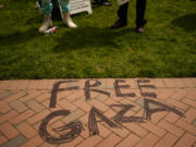 "Free Gaza" is written on the path in front of a pro-Palestinian encampment at the University of Washington campus Monday, April 29, 2024, in Seattle. The group is demanding that the university divest from Israel and cut ties with Boeing, which manufactures products used by Israel Defense Forces.