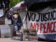 People gather near a student encampment on the campus of George Washington University in Washington, Friday, May 3, 2024, to protest the Israel-Hamas war.