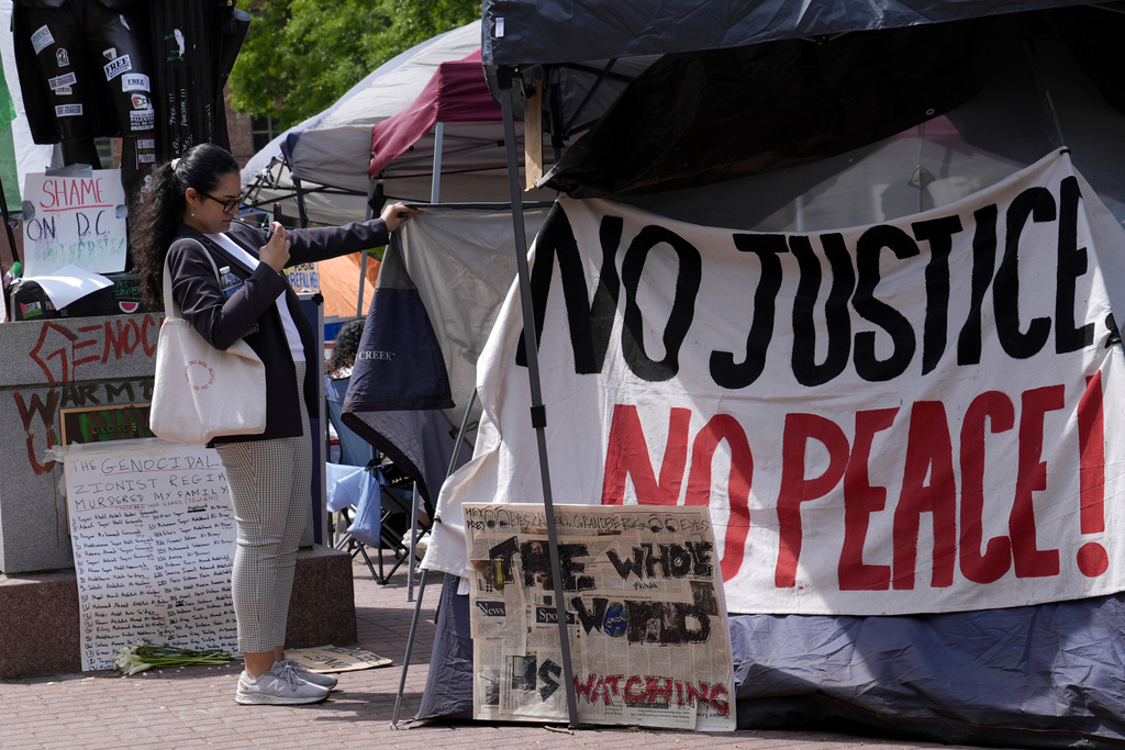 People gather near a student encampment on the campus of George Washington University in Washington, Friday, May 3, 2024, to protest the Israel-Hamas war.