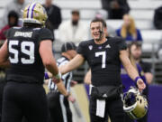 Washington quarterback Will Rogers III greets teammate Zachary Henning (59) during the NCAA college football team's spring game Friday, May 3, 2024, in Seattle.