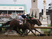 Sierra Leone with jockey Tyler Gaffalione (2), Forever Young with jockey Ryusei Sakai and Mystik Dan with jockey Brian Hernandez Jr., cross the finish line at Churchill Downs during the 150th running of the Kentucky Derby horse race, Saturday, May 4, 2024, in Louisville, Ky.