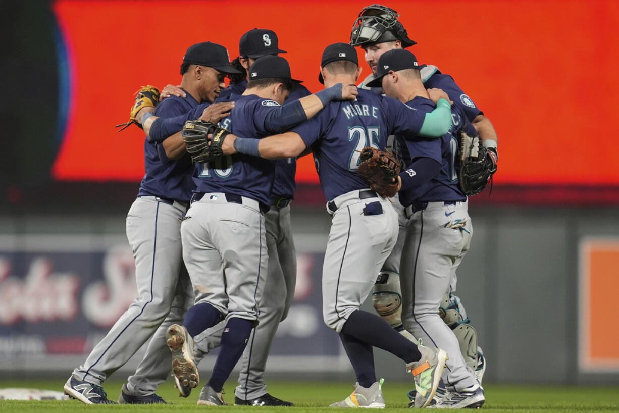 Seattle Mariners players celebrate after the 10-6 win against the Minnesota Twins of a baseball game Tuesday, May 7, 2024, in Minneapolis.