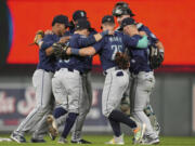 Seattle Mariners players celebrate after the 10-6 win against the Minnesota Twins of a baseball game Tuesday, May 7, 2024, in Minneapolis.