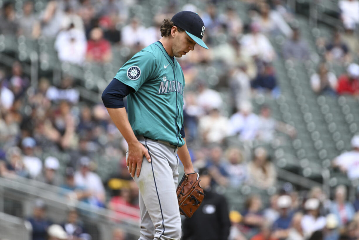 Seattle Mariners pitcher Logan Gilbert reacts after giving up his seventh run during the fourth inning of a baseball game, Thursday, May 9, 2024, in Minneapolis.